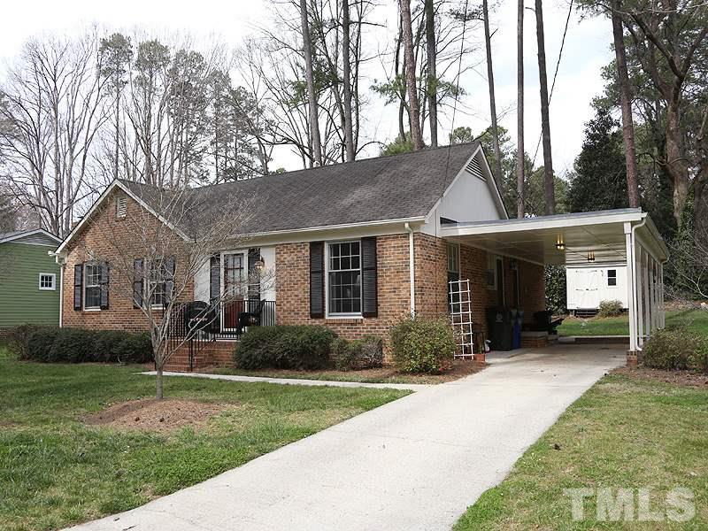 4916 Skidmore Street Raleigh, NC 27609 - Photo 1 of 12 a front view of house with yard outdoor seating and green space