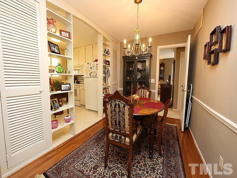 4916 Skidmore Street Raleigh, NC 27609 - Photo 5 of 12 a view of a dining room with furniture a chandelier and wooden floor