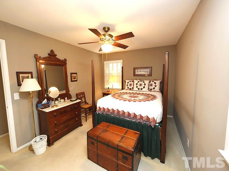 4916 Skidmore Street Raleigh, NC 27609 - Photo 7 of 12 a bedroom with a bed and wooden floor