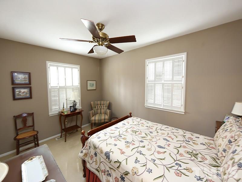 4916 Skidmore Street Raleigh, NC 27609 - Photo 9 of 12 a bedroom with a bed and wooden floor