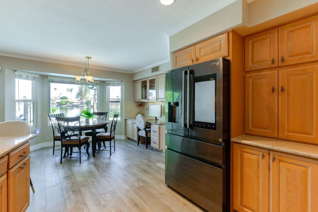 16439 South 34th Way Phoenix, AZ 85048 - Photo 16 of 33 a view of a dining room with furniture window and wooden floor