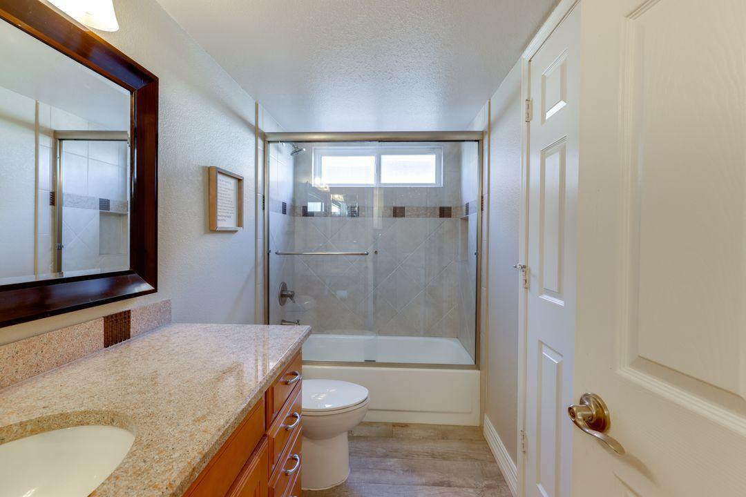 16439 South 34th Way Phoenix, AZ 85048 - Photo 4 of 33 a bathroom with a granite countertop sink toilet and shower