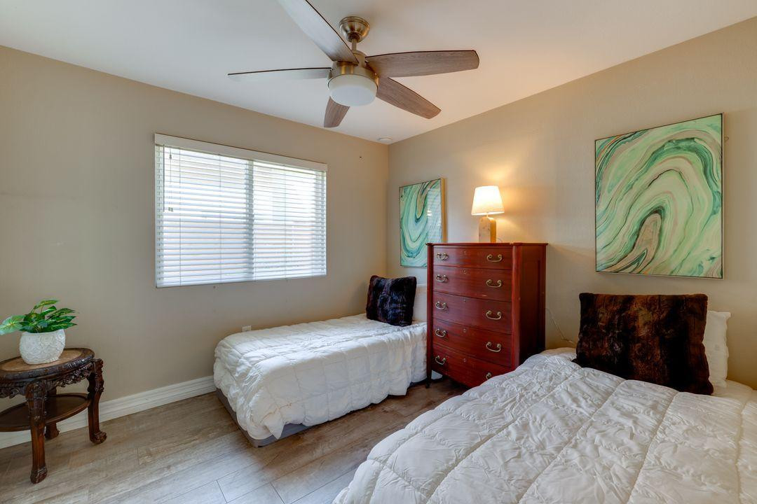 16439 South 34th Way Phoenix, AZ 85048 - Photo 7 of 33 a bedroom with two beds and a chair