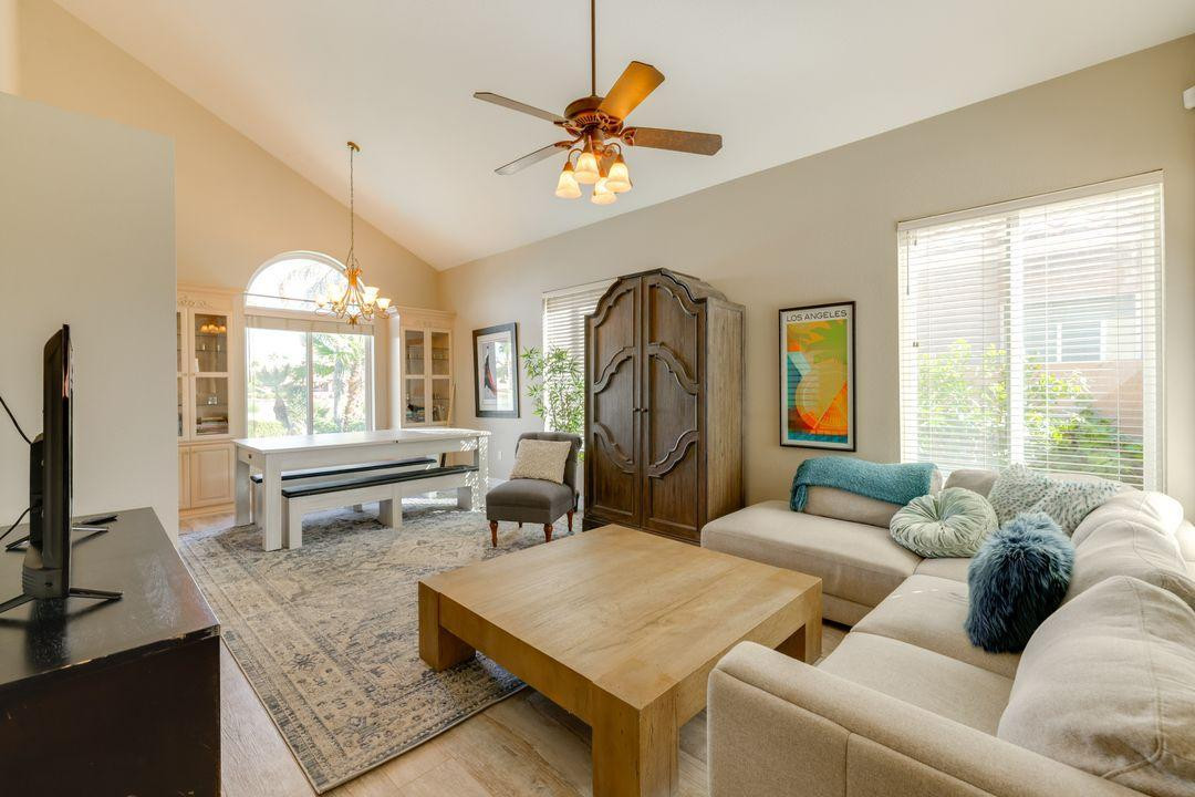 16439 South 34th Way Phoenix, AZ 85048 - Photo 10 of 33 a living room with furniture a chandelier and a large window