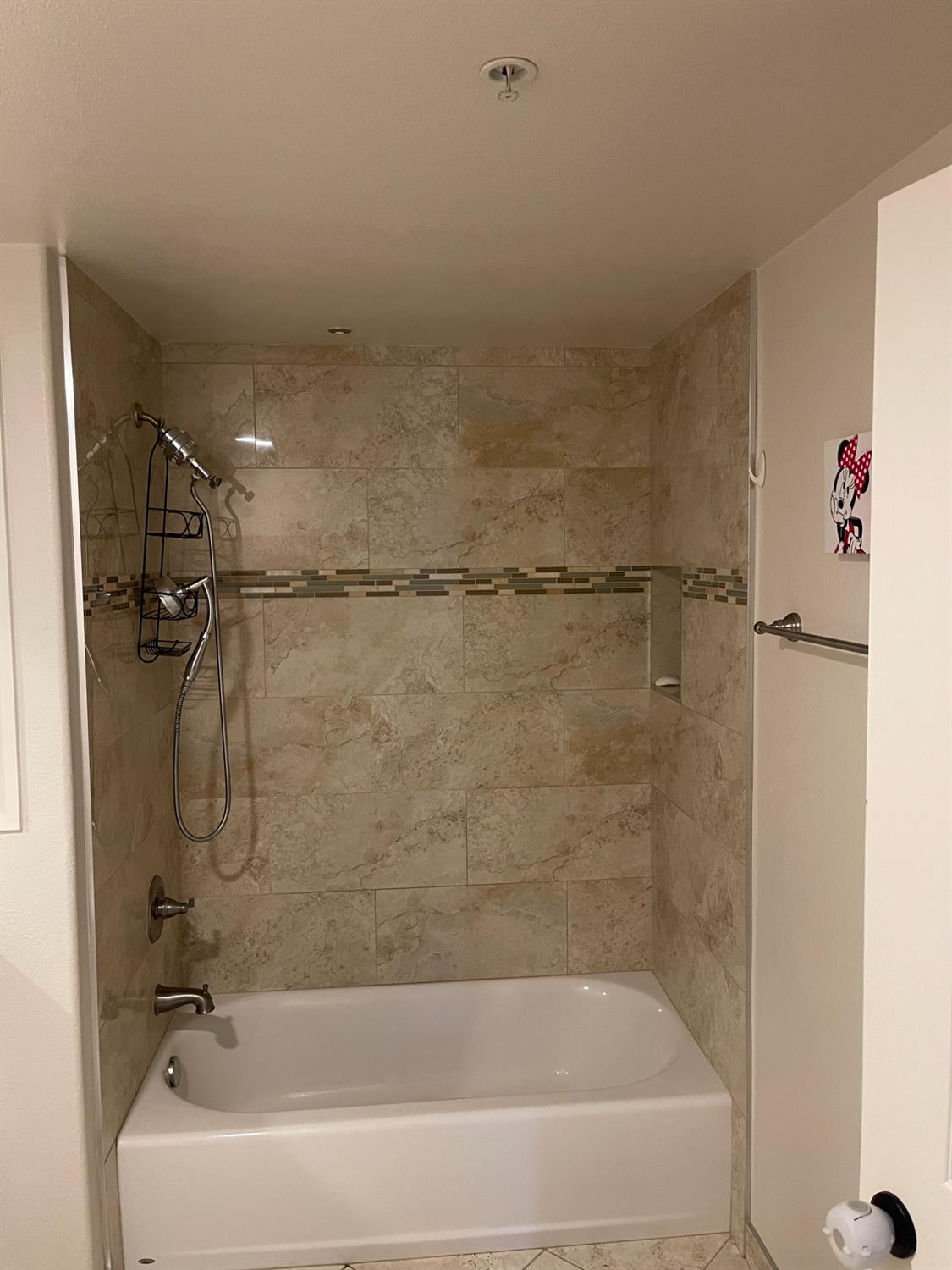 4200 East Commerce Way, Unit 2023 Sacramento, CA 95834 - Photo 11 of 12 a bathroom with a shower and a bath tub
