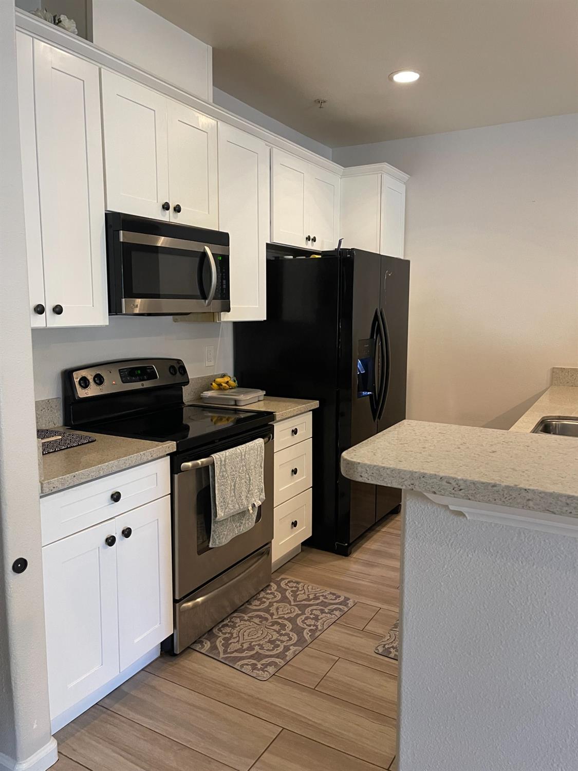 4200 East Commerce Way, Unit 2023 Sacramento, CA 95834 - Photo 3 of 12 a kitchen with stainless steel appliances a refrigerator stove and microwave