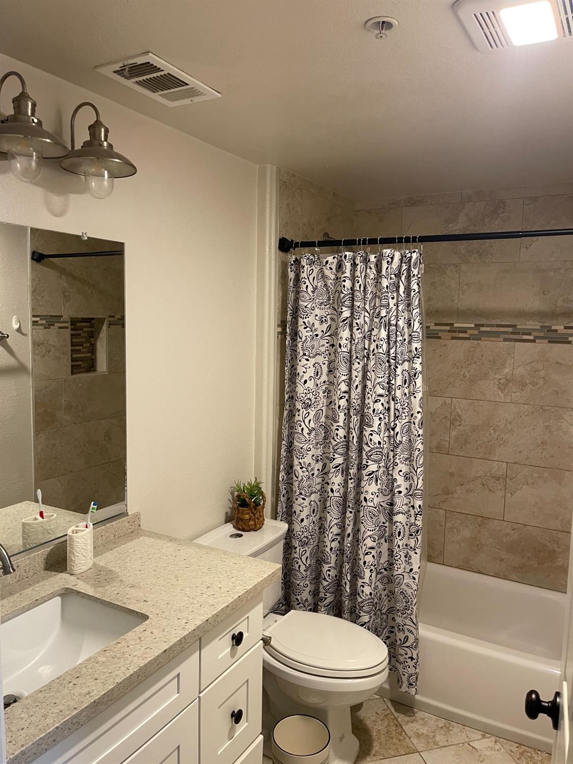 4200 East Commerce Way, Unit 2023 Sacramento, CA 95834 - Photo 10 of 12 a bathroom with a sink a toilet and shower