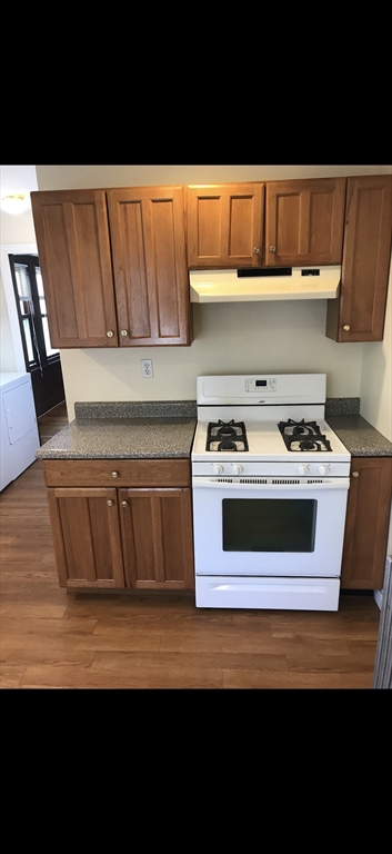 66 Brock Street, Unit 3 Boston, MA 02135 - Photo 1 of 15 a kitchen with a stove and a microwave