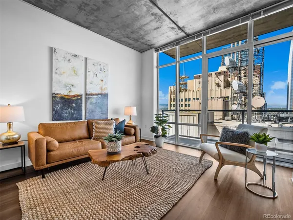 a living room with furniture a rug and a table