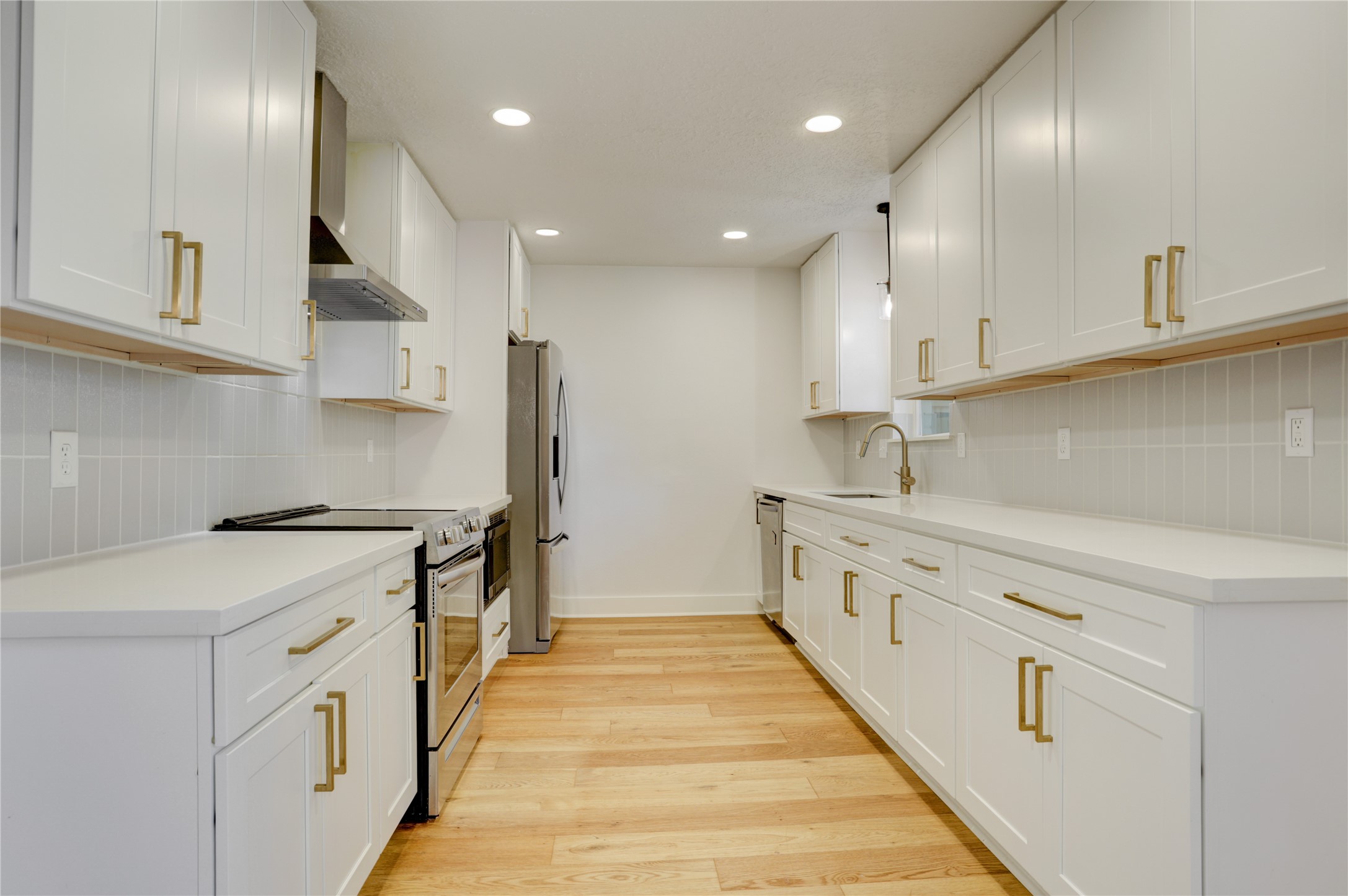 5514 Indigo Street Houston, TX 77096 - Photo 11 of 22 a kitchen with stainless steel appliances sink stove and cabinets