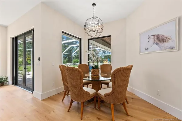 a kitchen with kitchen island white cabinets and stainless steel appliances