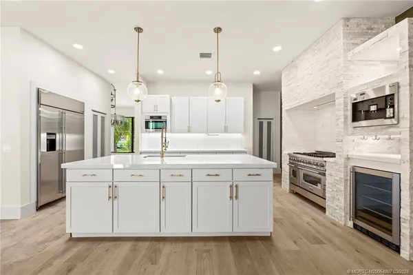 a stove top oven sitting inside of a kitchen