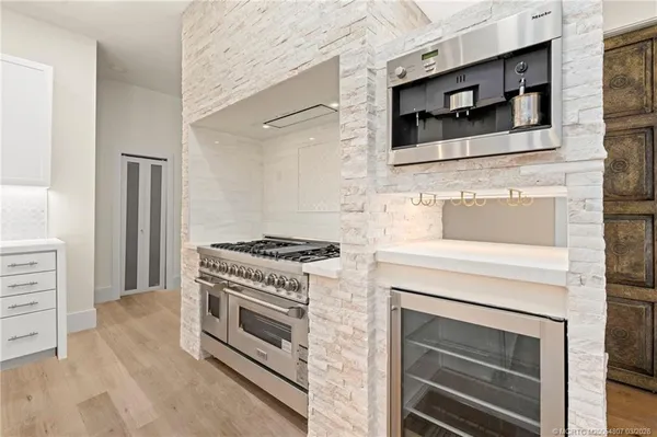a stove top oven sitting inside of a kitchen