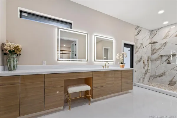 a bed sitting in a spacious bedroom next to a window