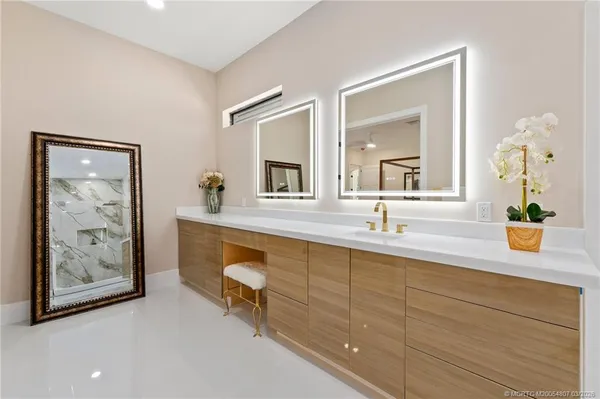 a bedroom with a large bed and a ceiling fan