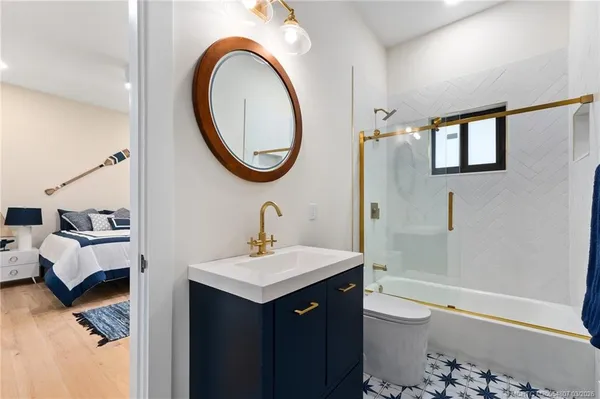 a bathroom with a sink a toilet and a mirror