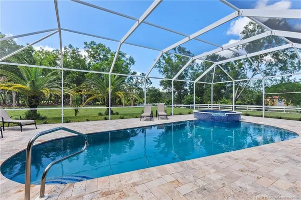 a view of a backyard with swimming pool