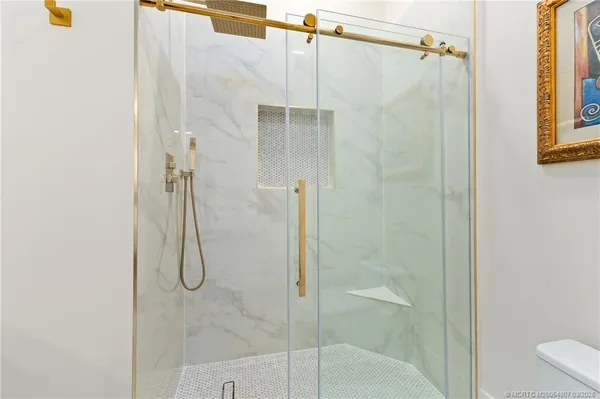 an aerial view of residential houses with outdoor space and trees