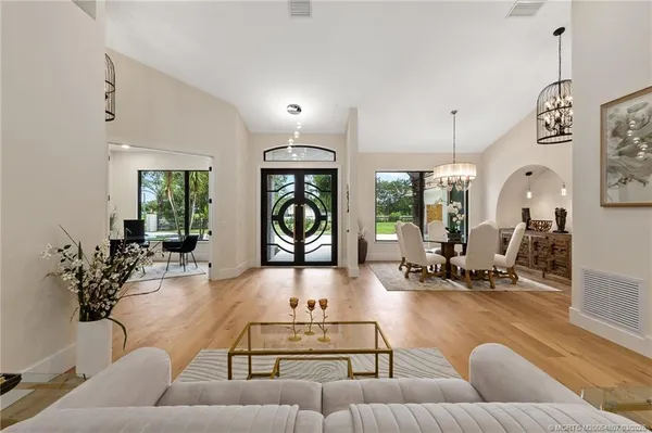 a living room with furniture and large windows