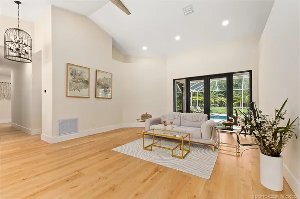a view of a dining room with furniture wooden floor and chandelier