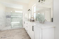 23109 West Skinner Road Wittmann, AZ 85361 - Photo 19 of 39 a bathroom with double vanity and a mirror