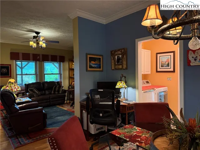 a view of a dining room with furniture and chandelier
