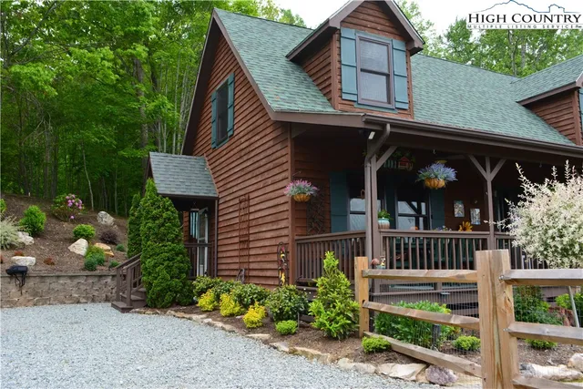 a view of a deck with furniture and garden