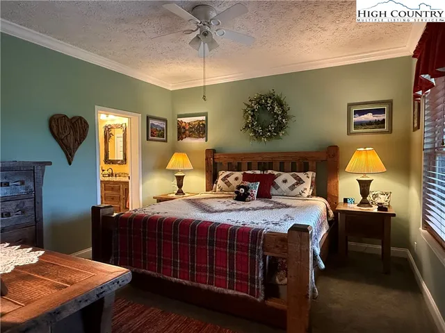 a bedroom with a bed and a potted plant