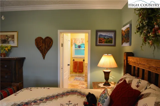 a living room with a couch and a dresser with wooden floor