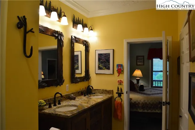 a bedroom with a bed and lamp