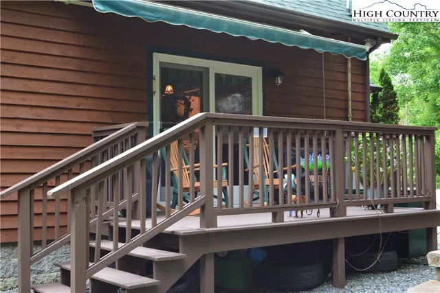a view of a house with a backyard and sitting area