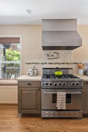 a kitchen with a sink stove and cabinets