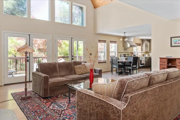 a spacious bedroom with a bed a couch and dresser