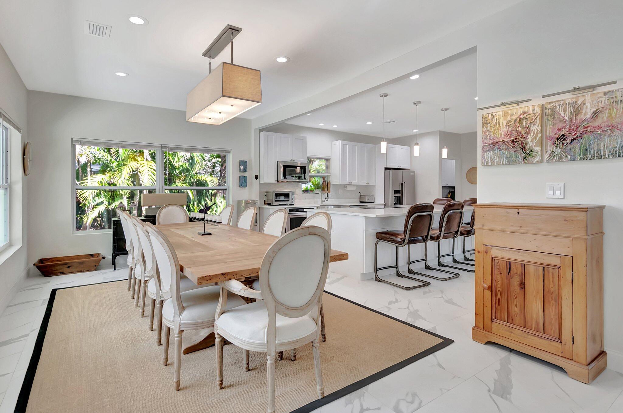 299 Northwest 10th Court Boca Raton, FL 33486 - Photo 12 of 42 a dining room with furniture a large window and wooden floor