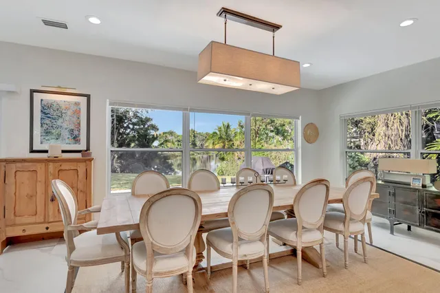 a dining room with furniture a chandelier and window