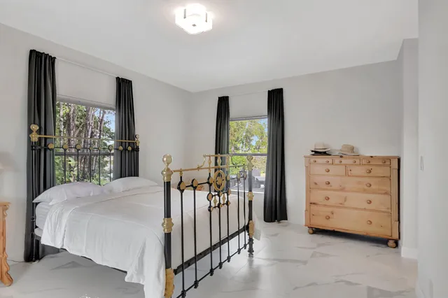 a bed room with a bed and a dresser