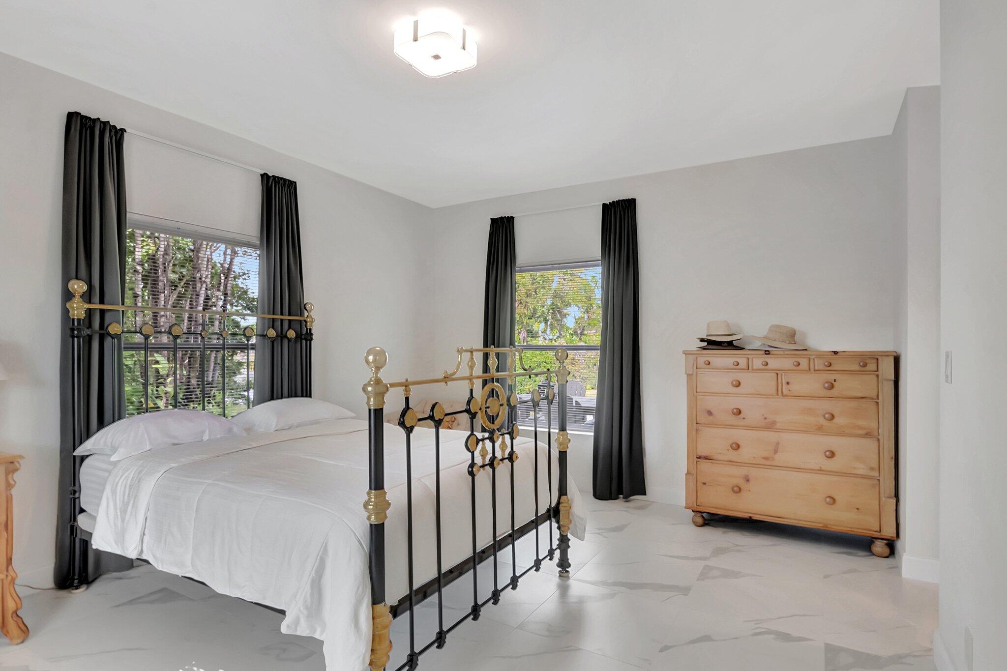 299 Northwest 10th Court Boca Raton, FL 33486 - Photo 20 of 42 a bed room with a bed and a dresser