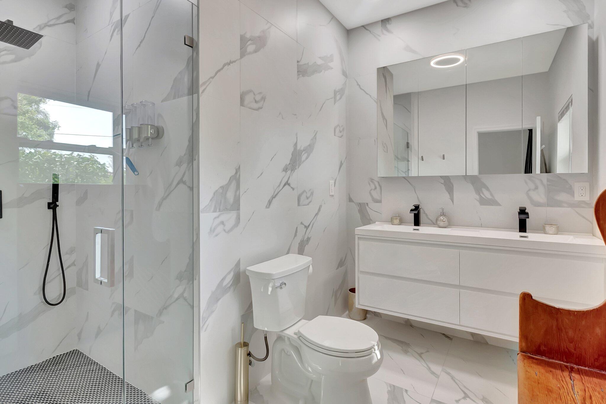 299 Northwest 10th Court Boca Raton, FL 33486 - Photo 21 of 42 a bathroom with a sink toilet and shower