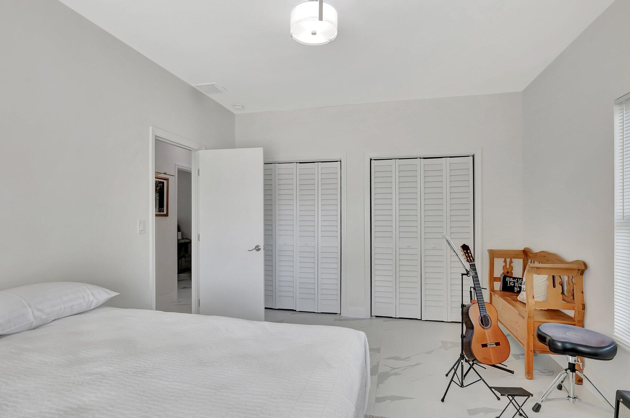 299 Northwest 10th Court Boca Raton, FL 33486 - Photo 24 of 42 a bedroom with a bed and a window