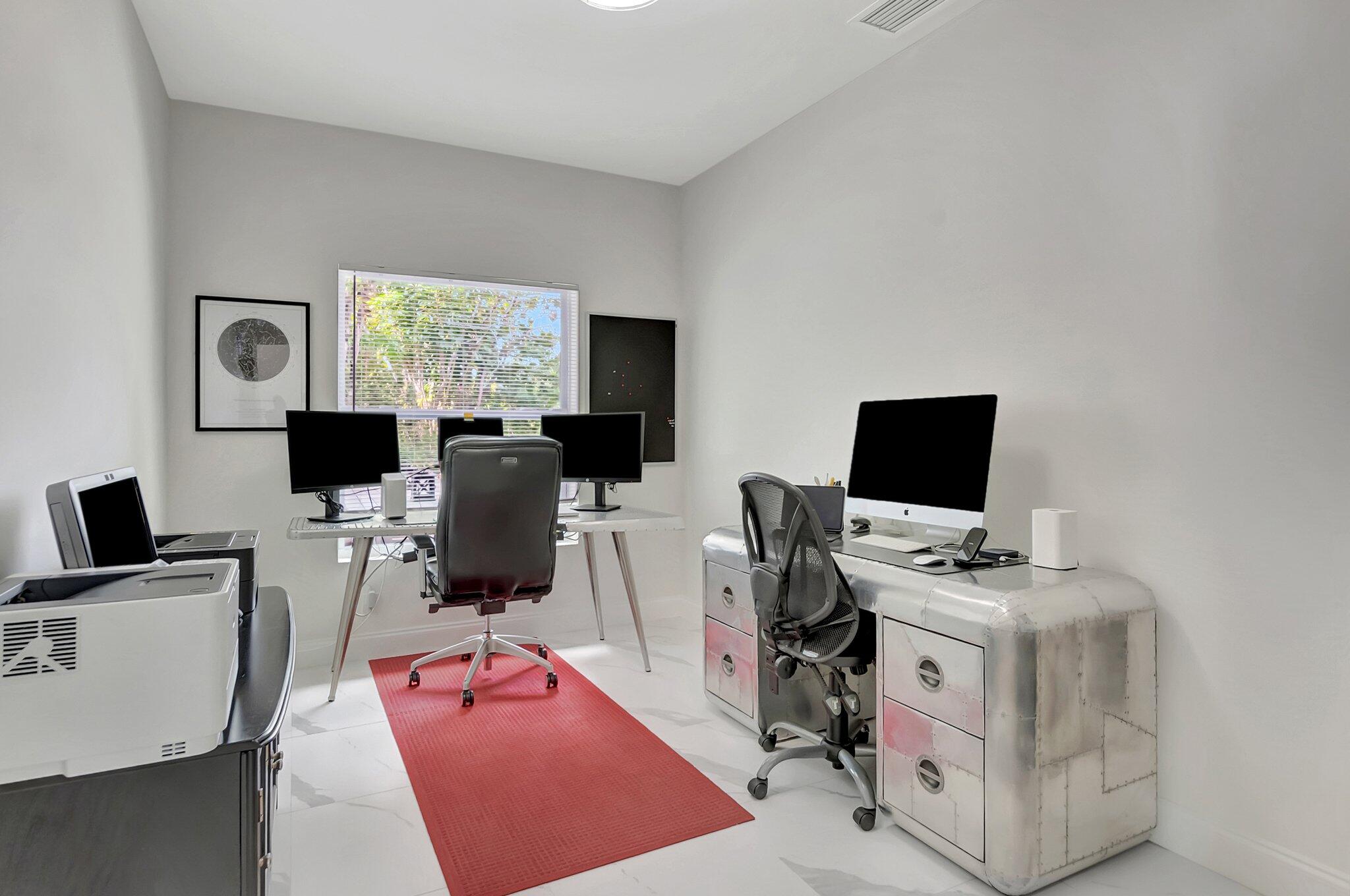 299 Northwest 10th Court Boca Raton, FL 33486 - Photo 26 of 42 a view of a workspace with furniture and a flat screen tv