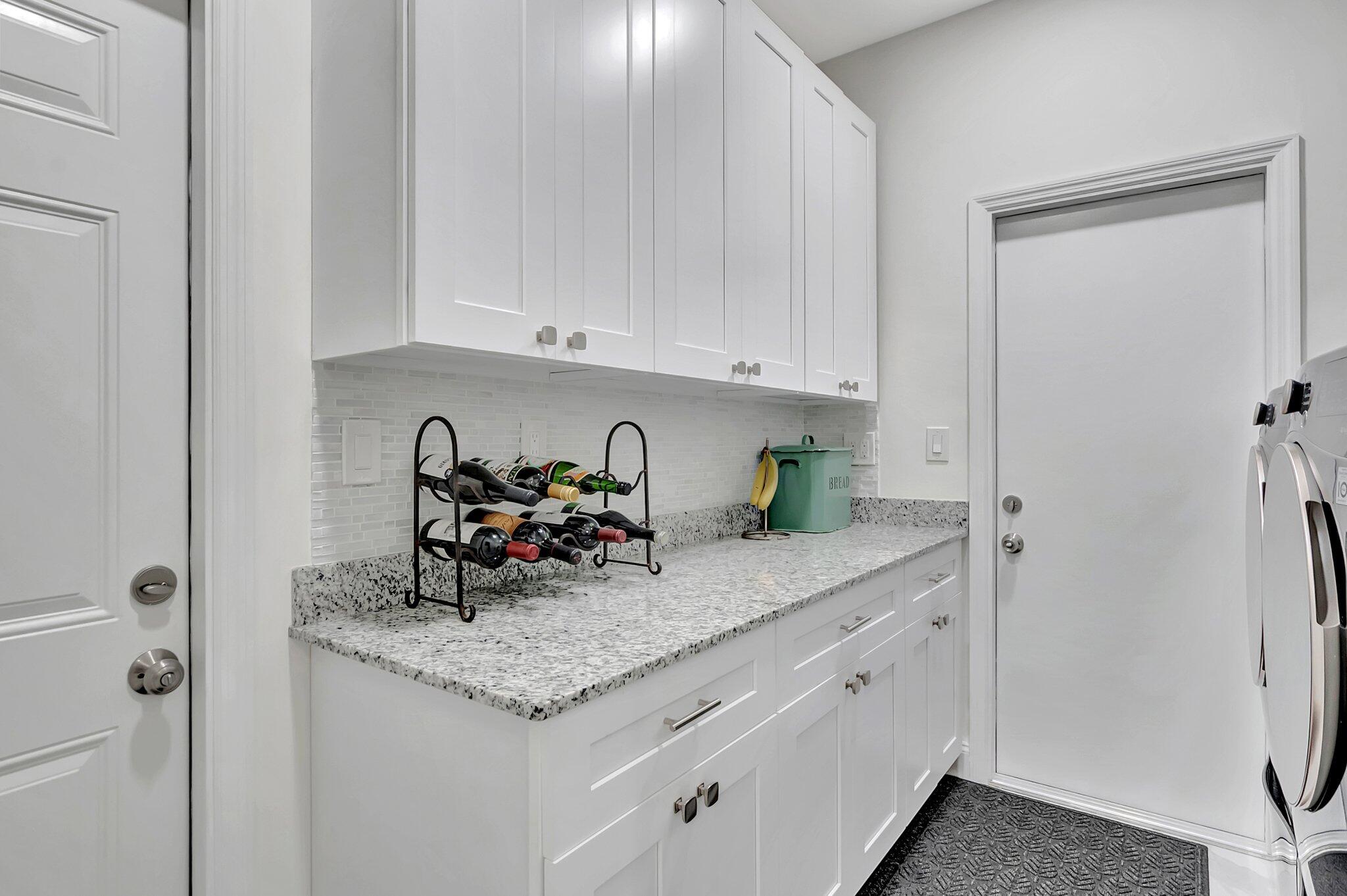 299 Northwest 10th Court Boca Raton, FL 33486 - Photo 28 of 42 a kitchen with stainless steel appliances granite countertop a sink stove and cabinets