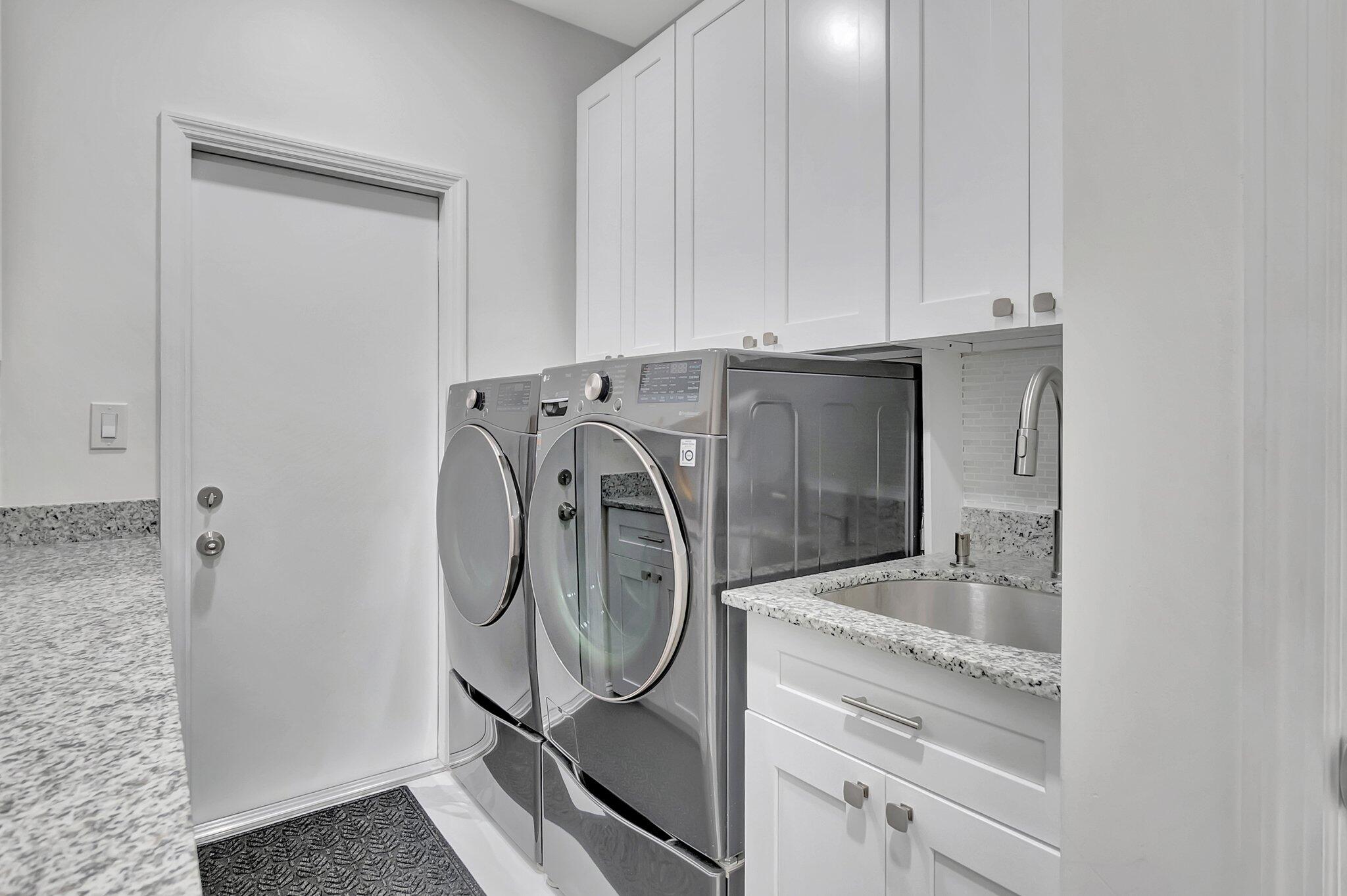 299 Northwest 10th Court Boca Raton, FL 33486 - Photo 29 of 42 a utility room with dryer and washer