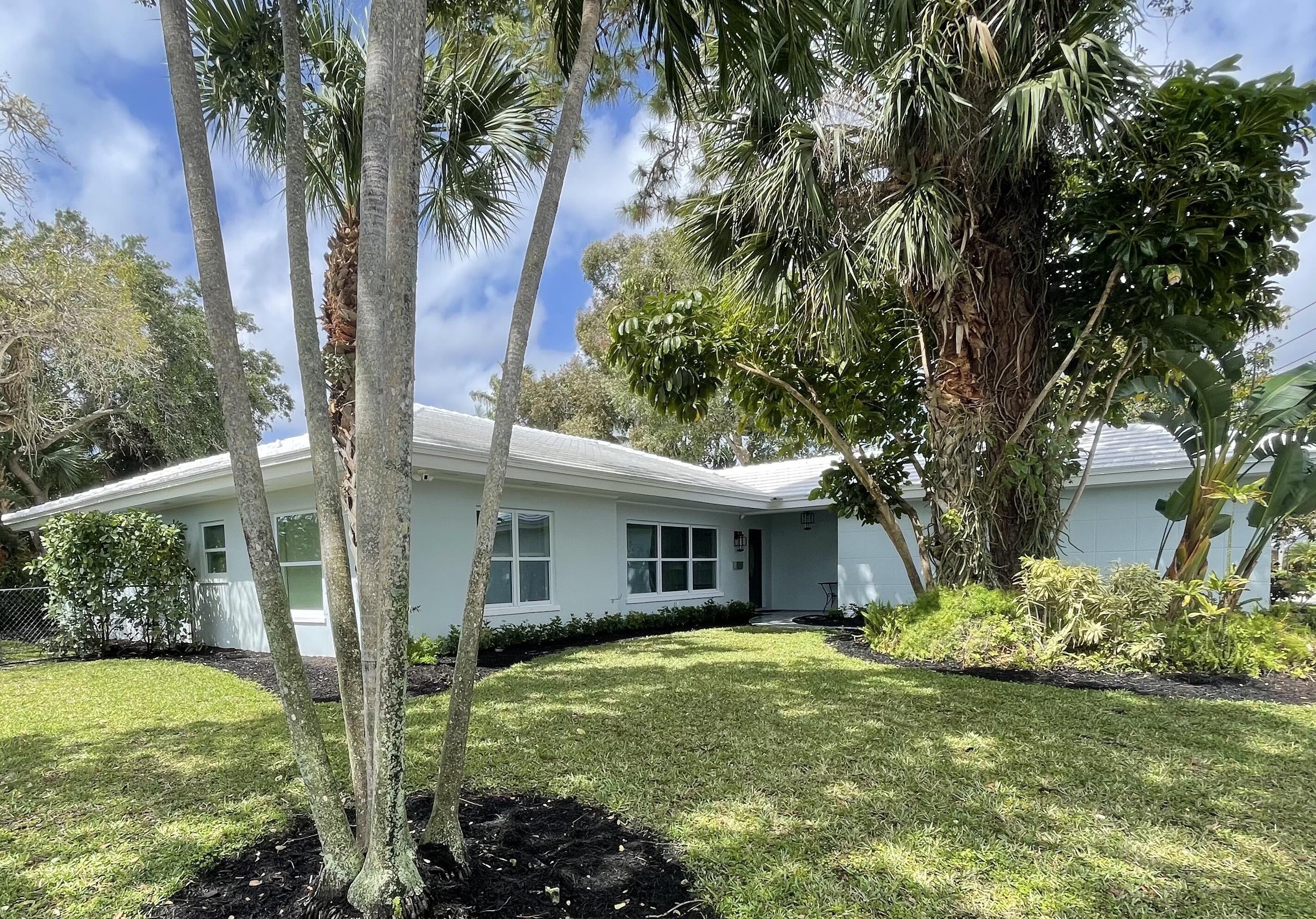 299 Northwest 10th Court Boca Raton, FL 33486 - Photo 3 of 42 a backyard of a house with plants and large tree