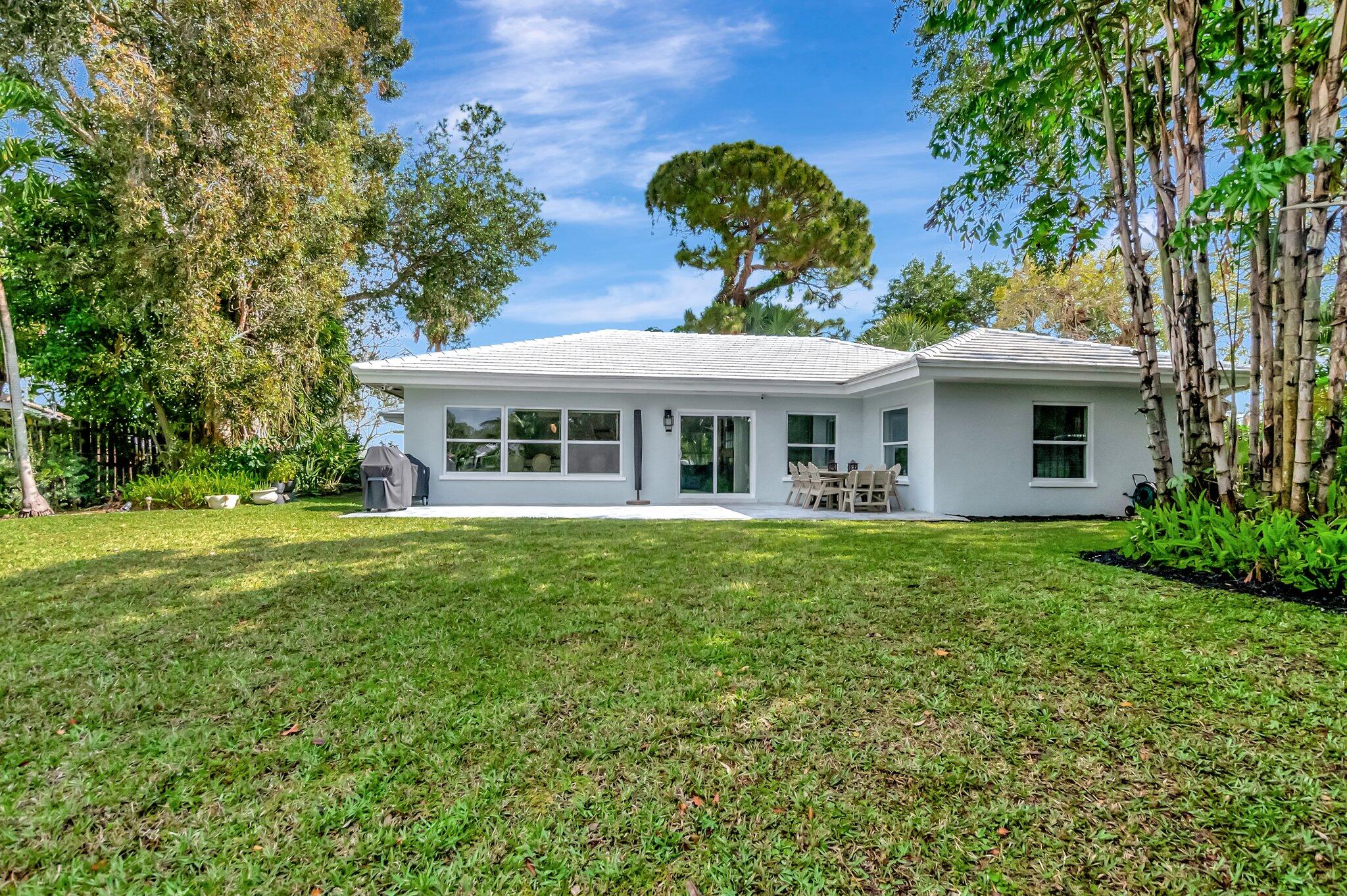 299 Northwest 10th Court Boca Raton, FL 33486 - Photo 31 of 42 a front view of a house with garden