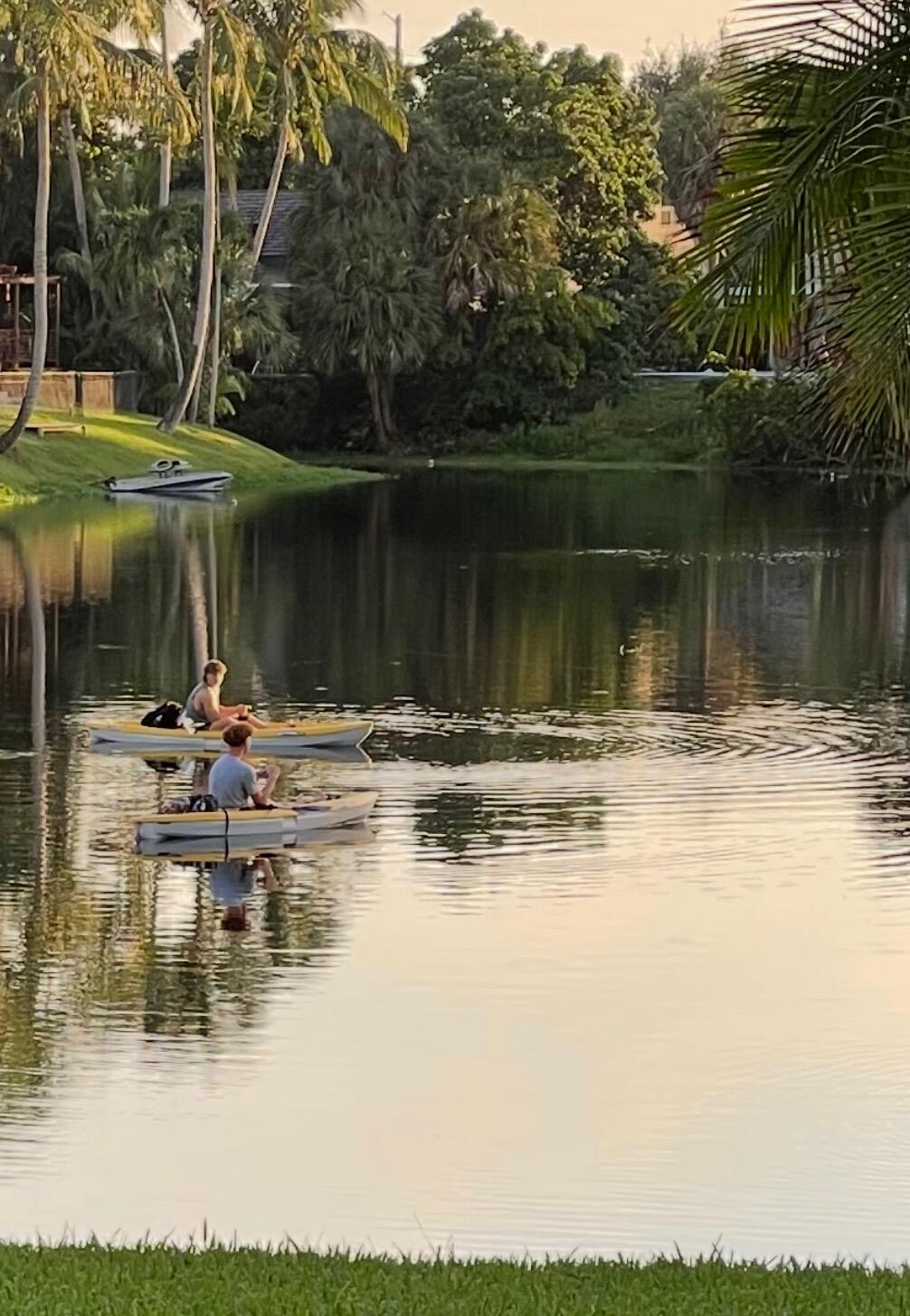 299 Northwest 10th Court Boca Raton, FL 33486 - Photo 38 of 42 a view of a lake with a table and chairs