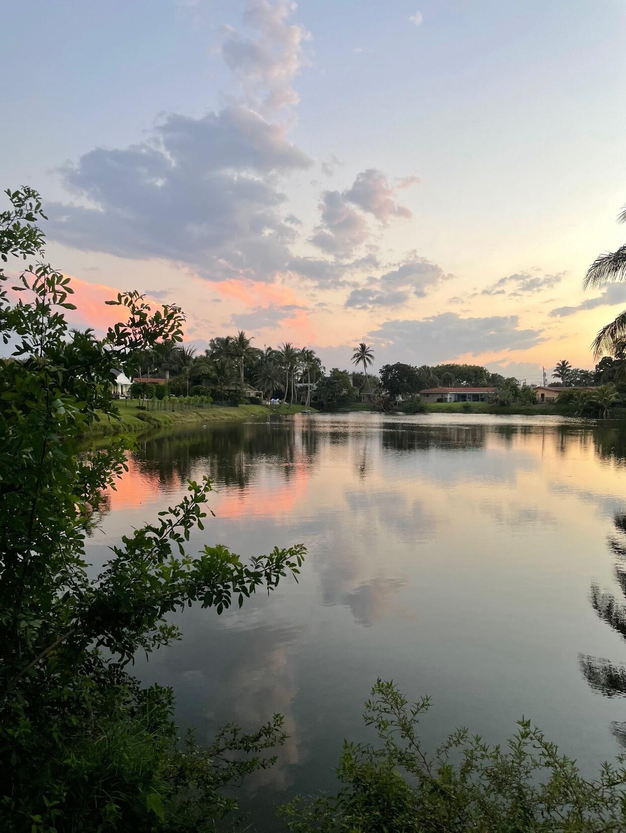 299 Northwest 10th Court Boca Raton, FL 33486 - Photo 40 of 42 a view of a lake with houses in the back