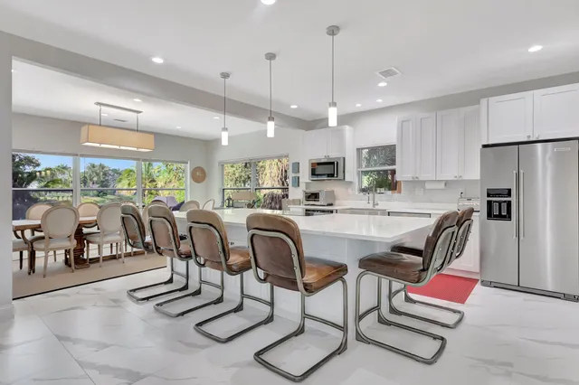 a dinning room and kitchen with a large window