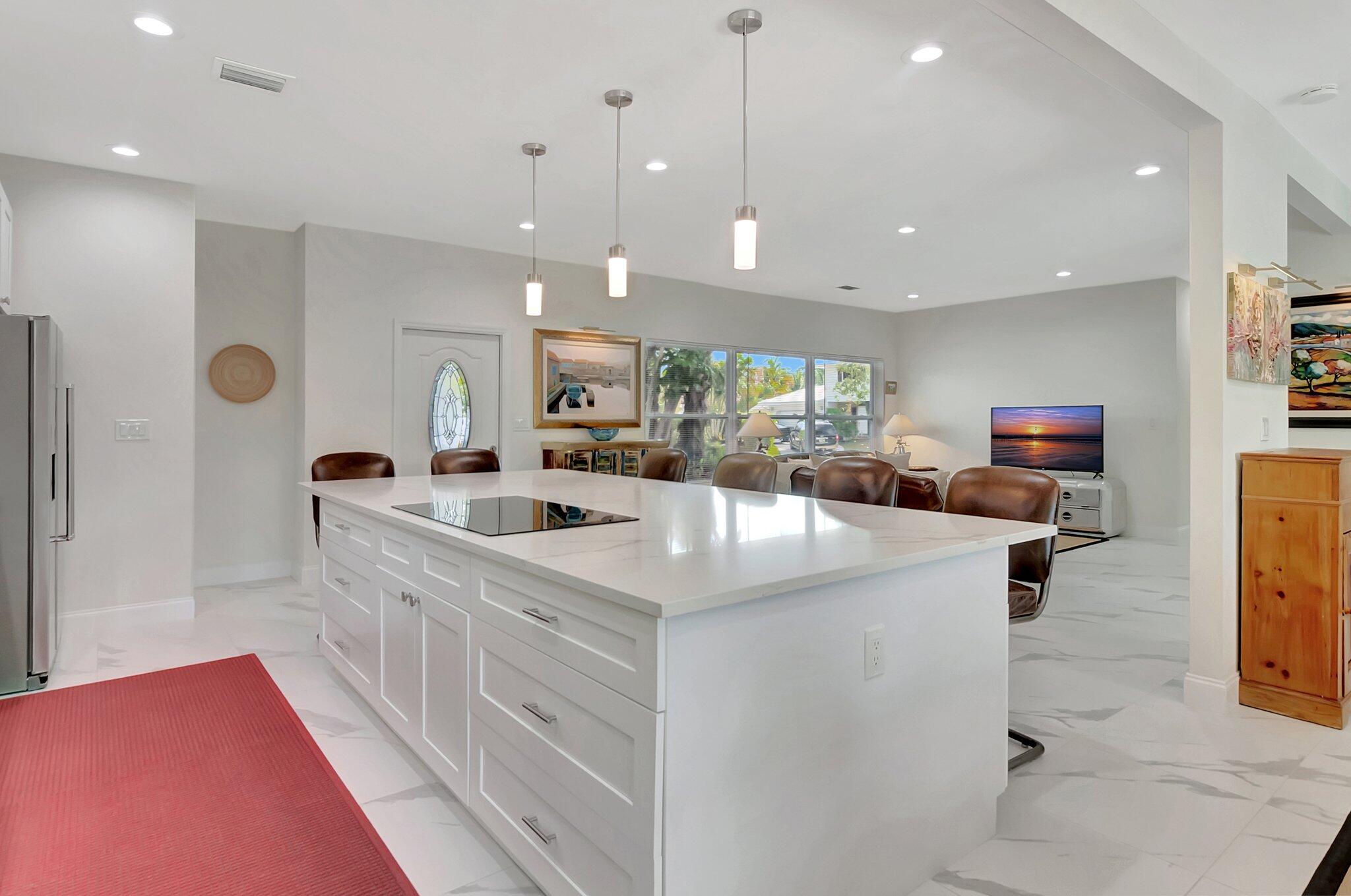 299 Northwest 10th Court Boca Raton, FL 33486 - Photo 10 of 42 a kitchen with kitchen island a sink appliances and a counter top space