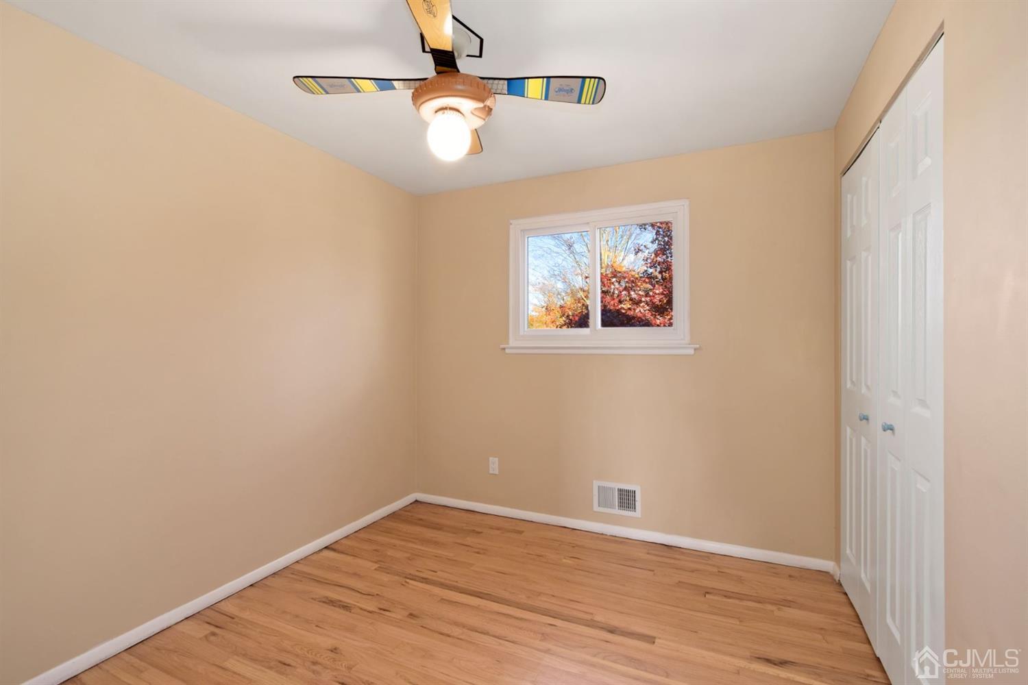 50 Gramercy Road Old Bridge, NJ 08857 - Photo 11 of 23 an empty room with wooden floor and windows