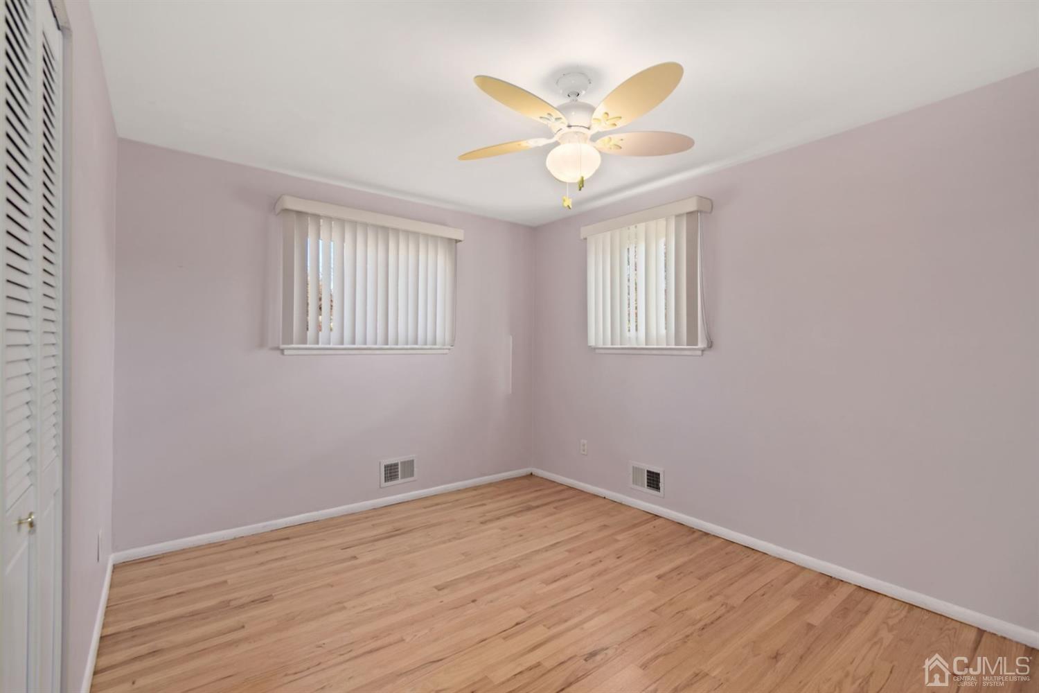 50 Gramercy Road Old Bridge, NJ 08857 - Photo 12 of 23 wooden floor in an empty room with a window